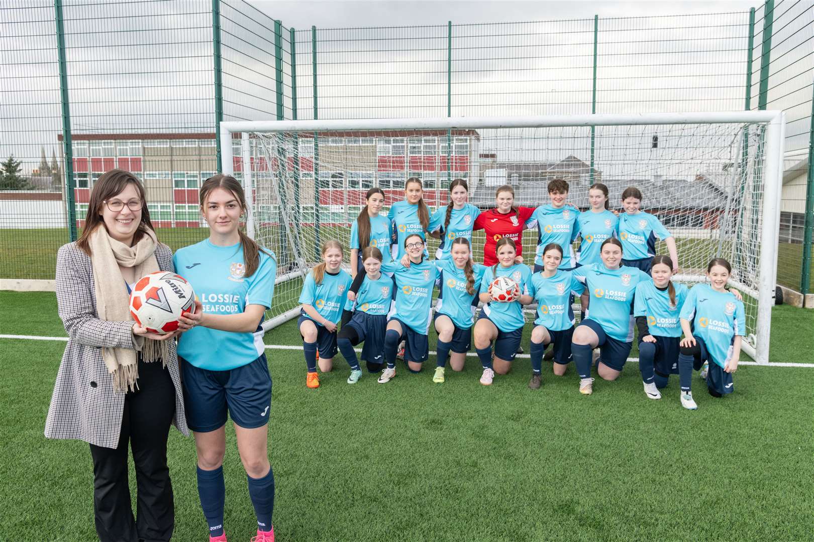 ASL Technical Systems Manager Tammy Rendall congratulated BCHS senior team player Skye Milne and her team-mates on their choice of new strips purchased with a £500 donation from the firm. Picture: Beth Taylor