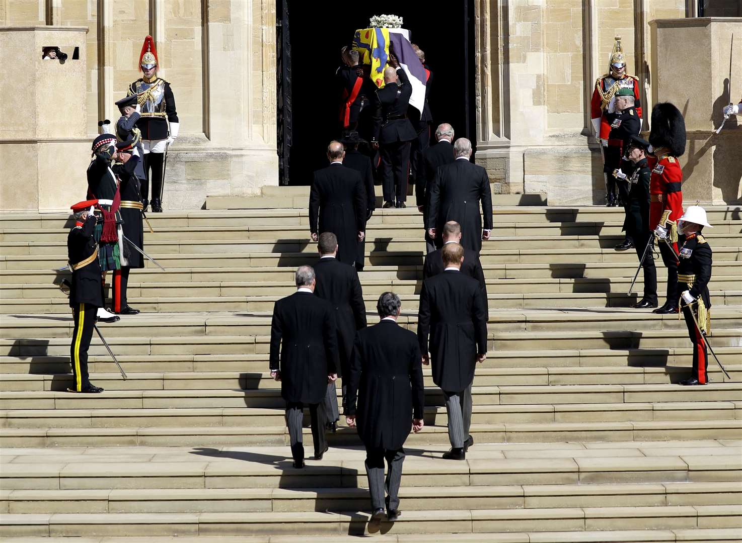 The Duke of Edinburgh’s coffin is taken into the chapel, followed by members of his family (Kirsty Wrigglesworth/PA)