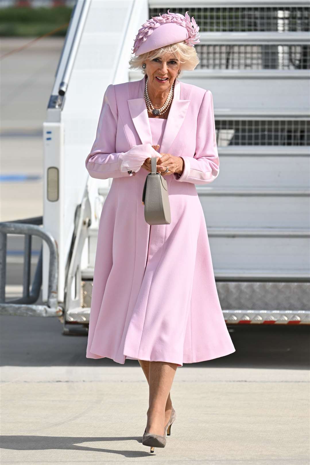 The Queen, dressed in pink, arrives at Orly Airport in Paris (Tim Rooke/PA)