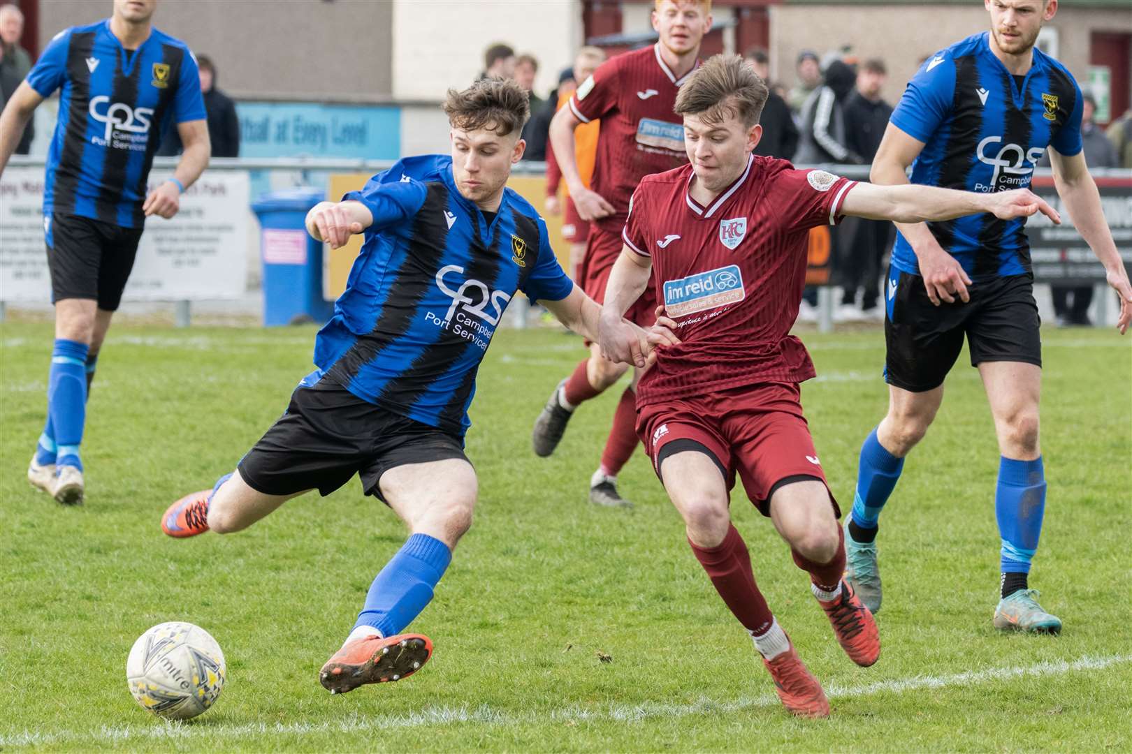 Huntly's Lyall Booth tries to clear the ball away from Keith's Nathan McKeown. ..Keith F.C. v Huntly F.C. at Kynoch Park...Picture: Beth Taylor.
