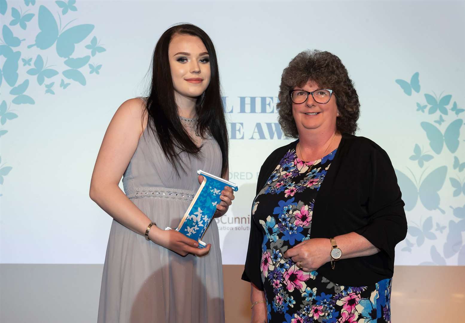 Teenager Katie MacDonald receives her Local Hero Courage Award from Councillor Gillian Owen.