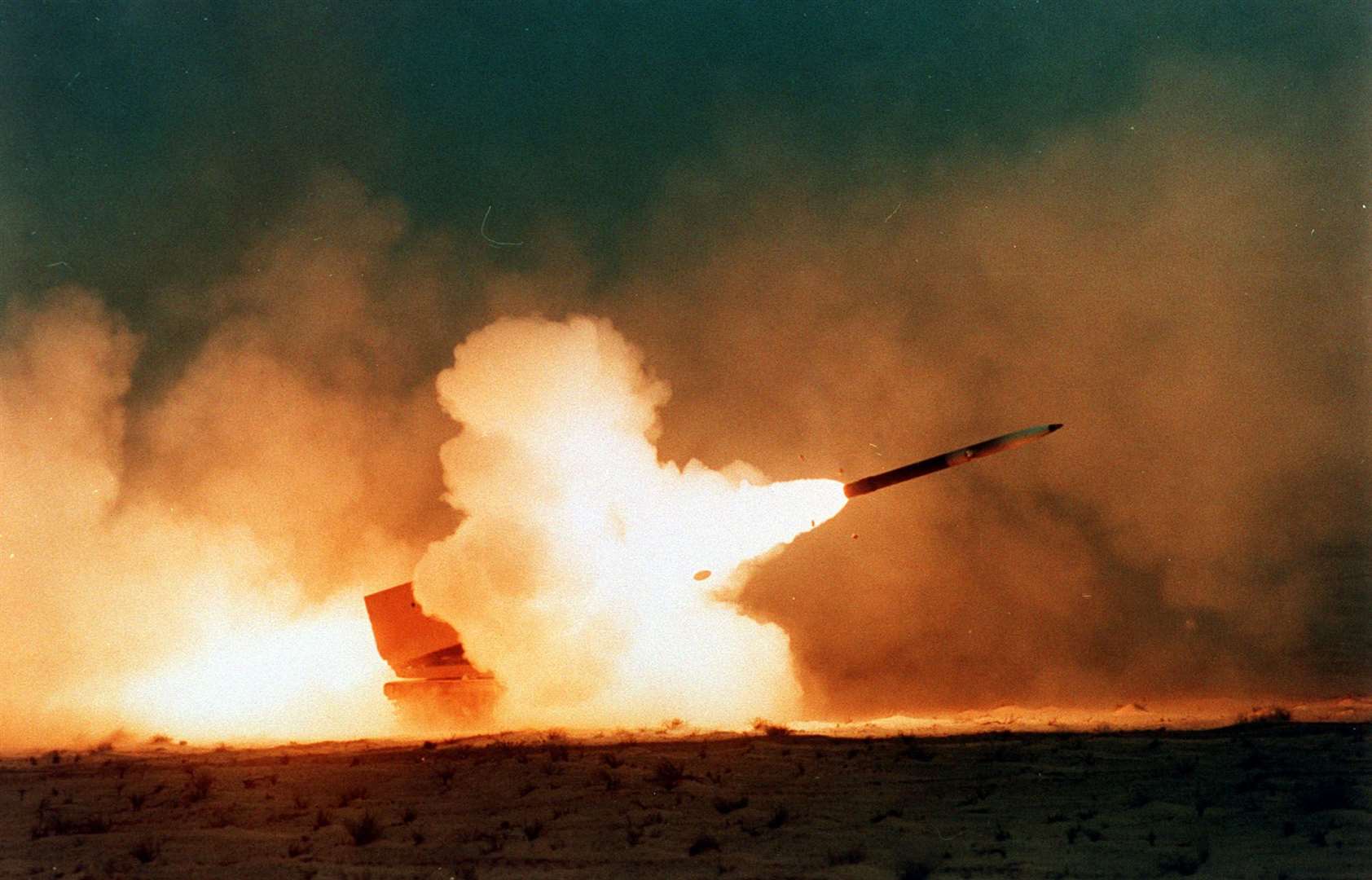 A multiple launch rocket system fired in the Saudi desert by 2nd Field Artillery during the Gulf War (Mike Moore/PA)