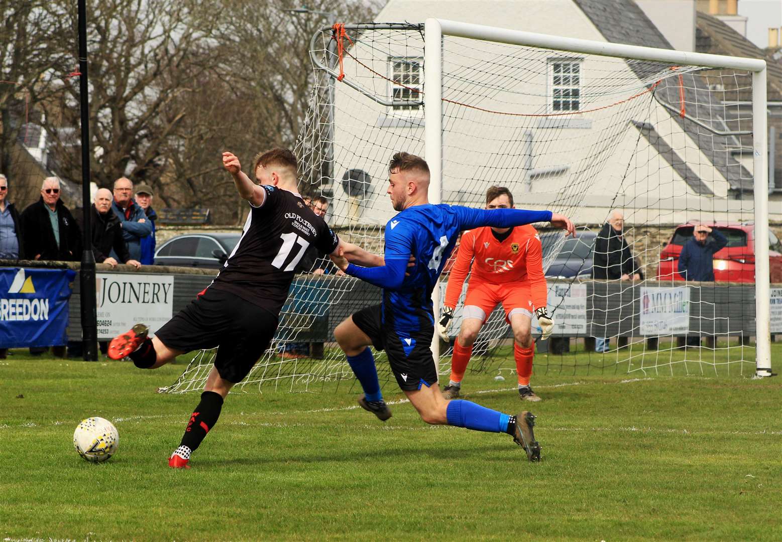 Cameron Heslop tries to block a cross from Mark Macadie. Photo: Alan Hendry.