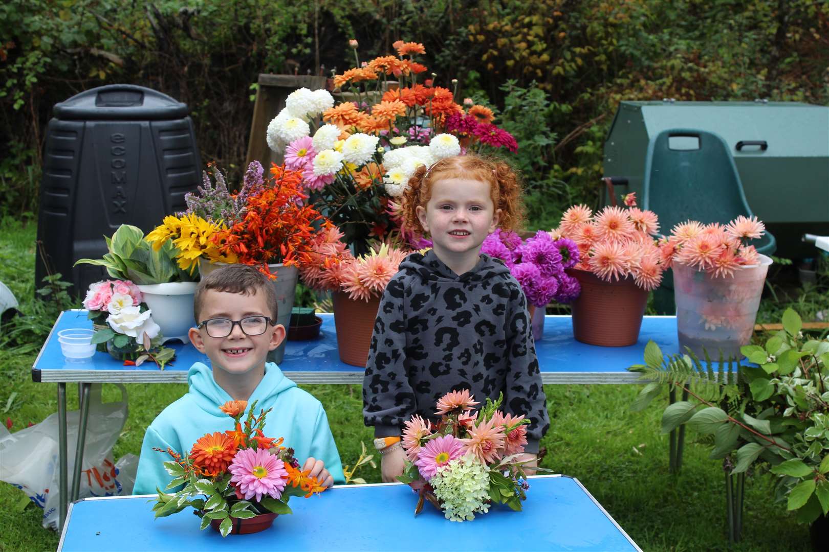 Wee visitors Ruaraidh and Ruby Urquhart show off their floral art efforts at Kemnay's Birley Bush open day. Picture: Griselda McGregor