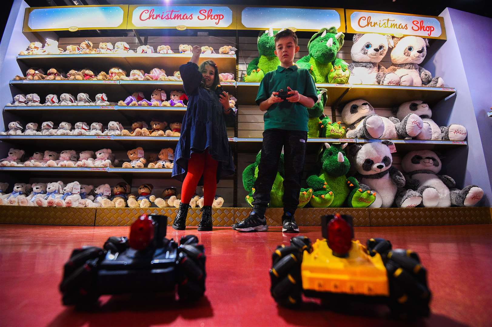 Millie, eight, and Max, nine, play with Laser Battle Hunters in the store (Kirsty O’Connor/PA)