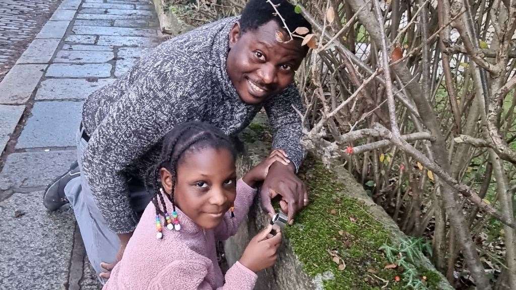 PhD student Thomas Daniya is pictured on the High Street in Old Aberdeen, with his daughter Beomhinya who helped him collect moss samples as part of his study.