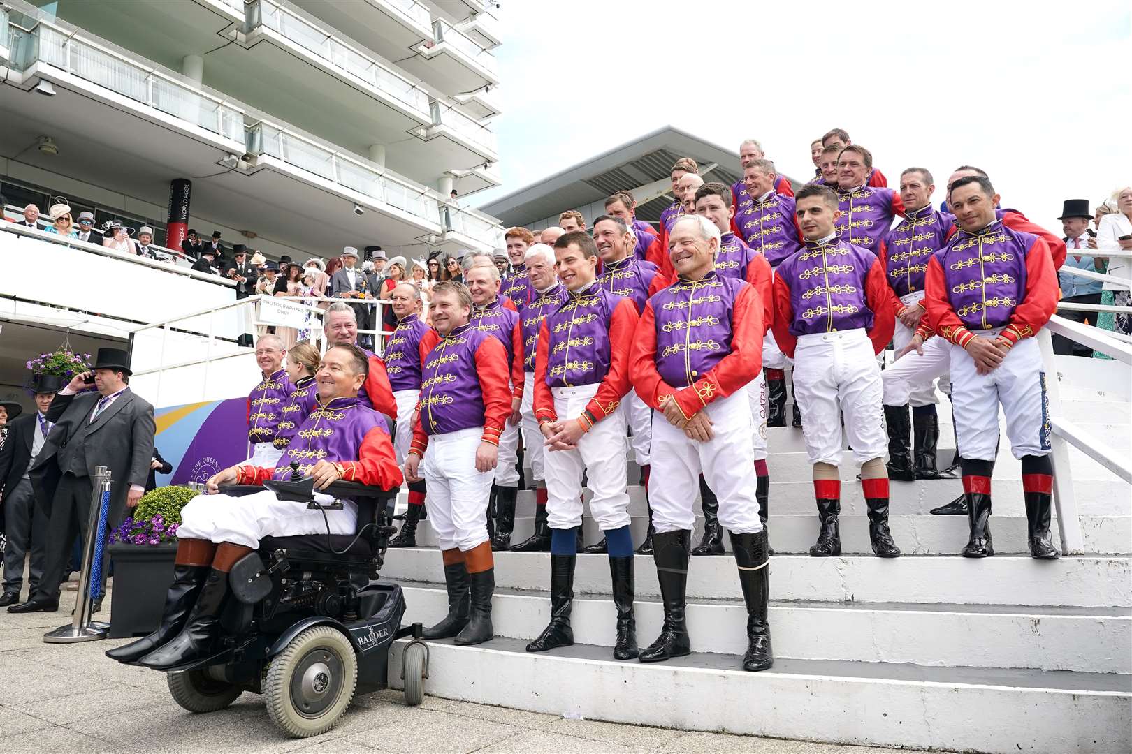Forty jockeys who have ridden horses for the Queen lined up in her racing colours at Epsom on Derby Day (Tim Goode/PA)
