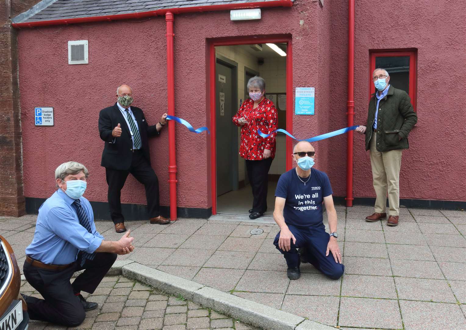 Councillors Iain Taylor, Alistair Forsyth, Sandy Duncan and Kevin Turner from Tesco watch as councillor Anne Stirling officially re-opened the toilets.