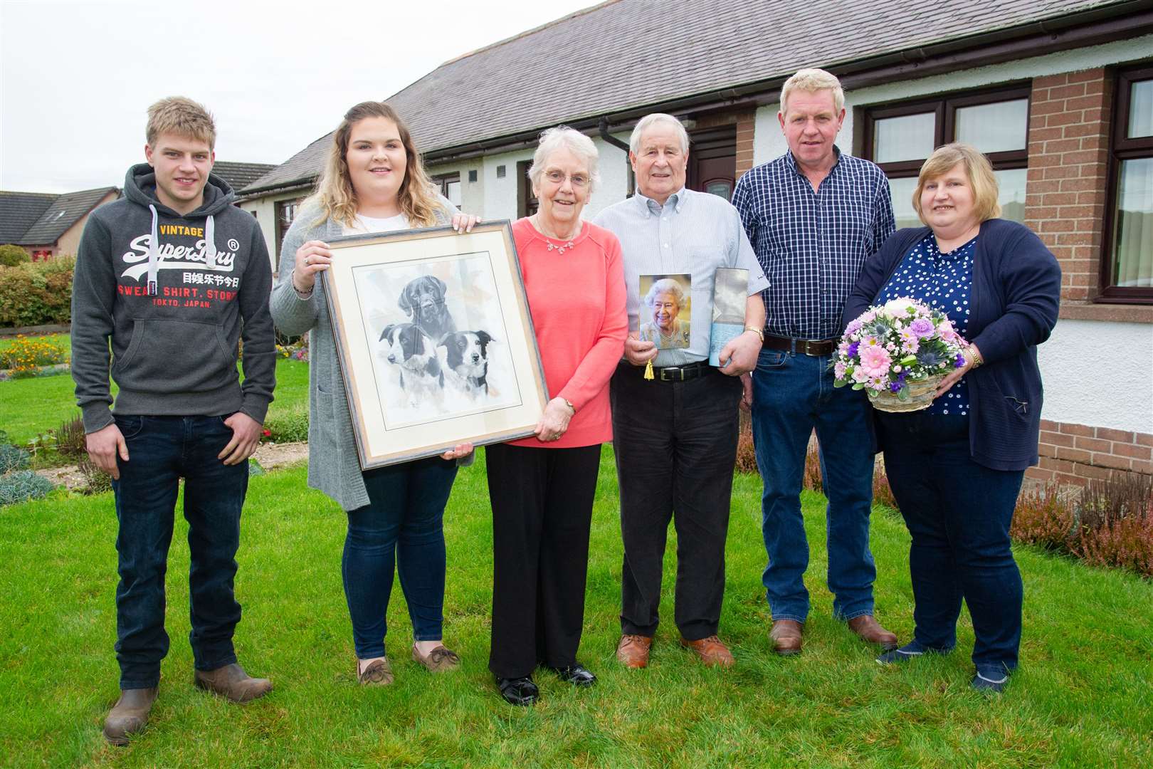 One for the family album, diamond couple Charlie and Edna Cameron with their grandchildren, Euan and Claire, son Charles and daughter in law Heather. The painting of the family's dogs was a gift from the family. Picture: Daniel Forsyth.