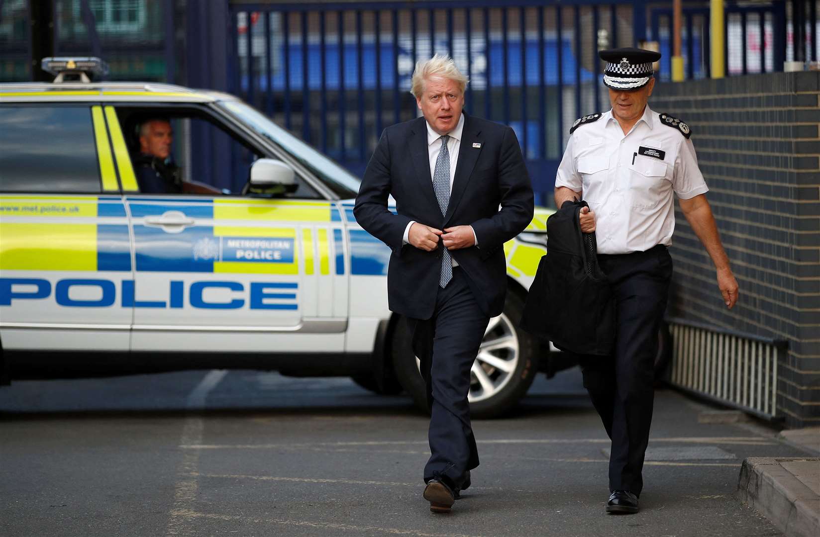 Mr Johnson and Stephen House, acting commissioner of the Metropolitan Police service (Peter Nicholls/PA)