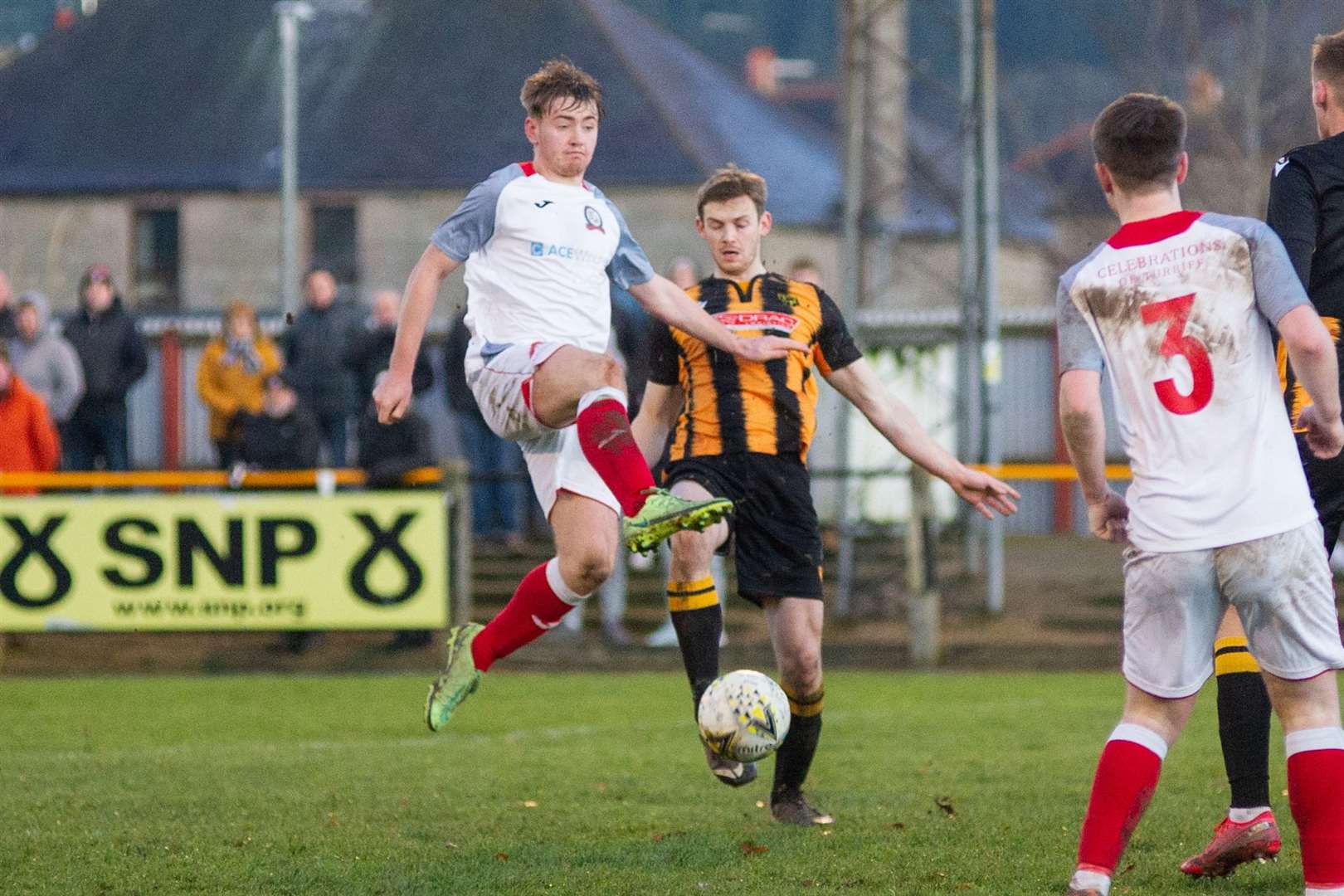 Turriff's Dylan Stuart leaps in front of Andy Hunter to clear the ball away. Picture: Daniel Forsyth..