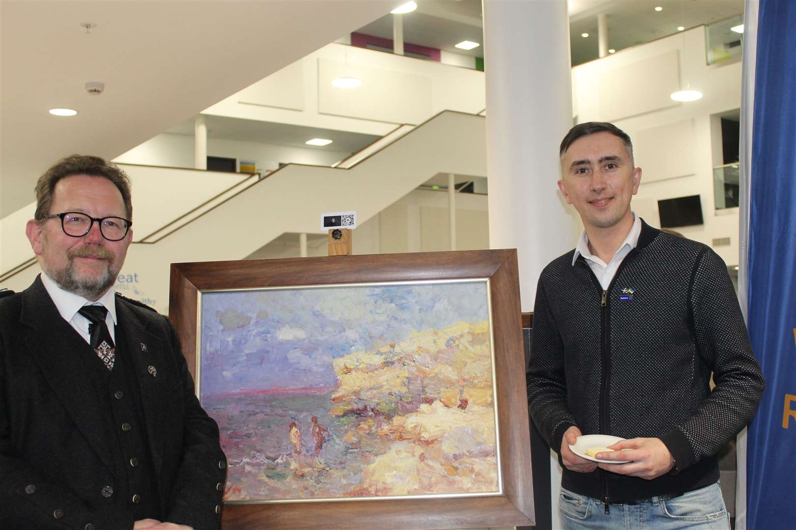 Councillor Neil Baillie admires a painting of the Crimea with art promoter Mykola Zinchenko at Monday's Ukraine-Scotland social evening at Inverurie communuty campus.