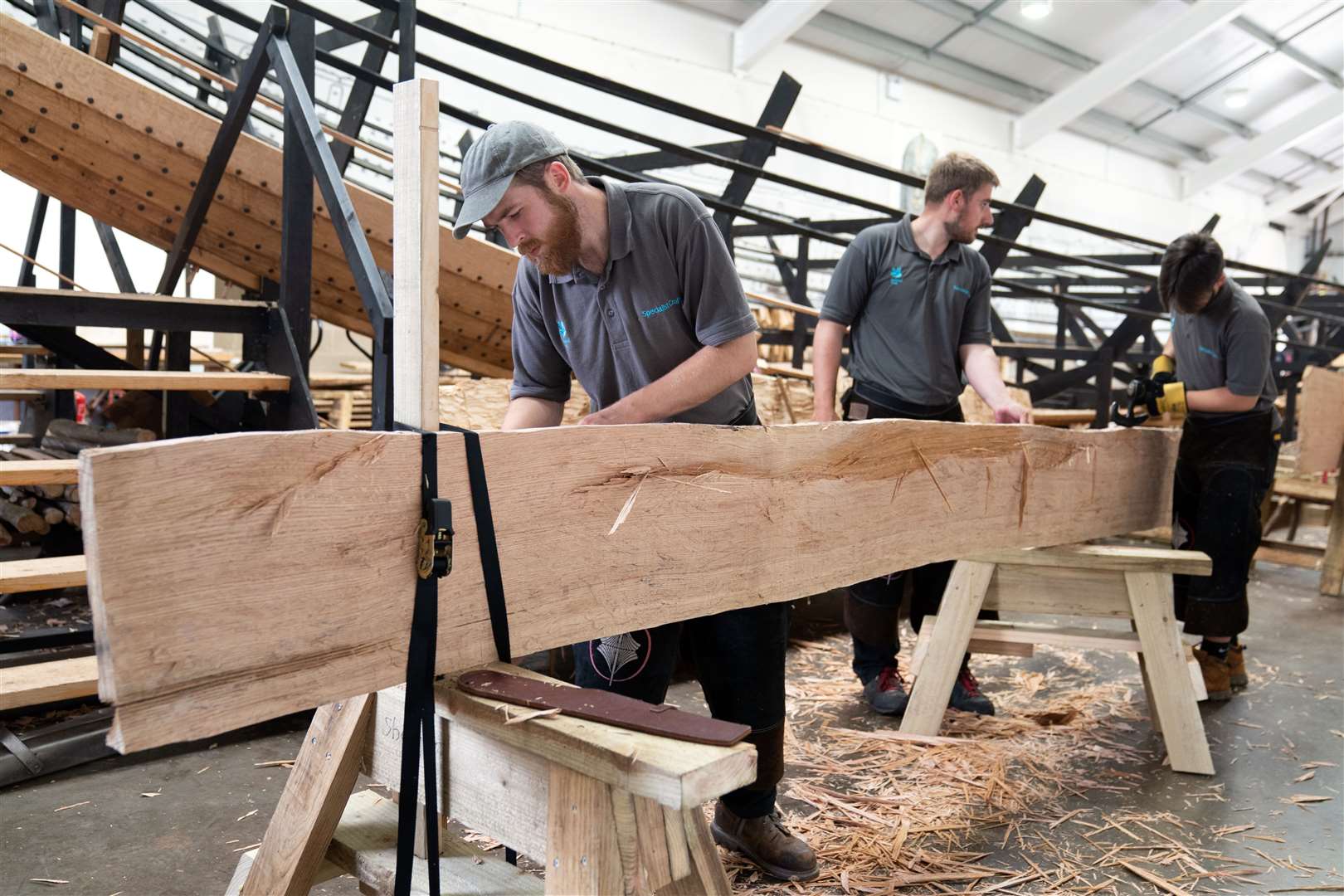 National Trust apprentice joiner Josh Bobbett (left) works on the replica of the Sutton Hoo longship (Joe Giddens/PA)