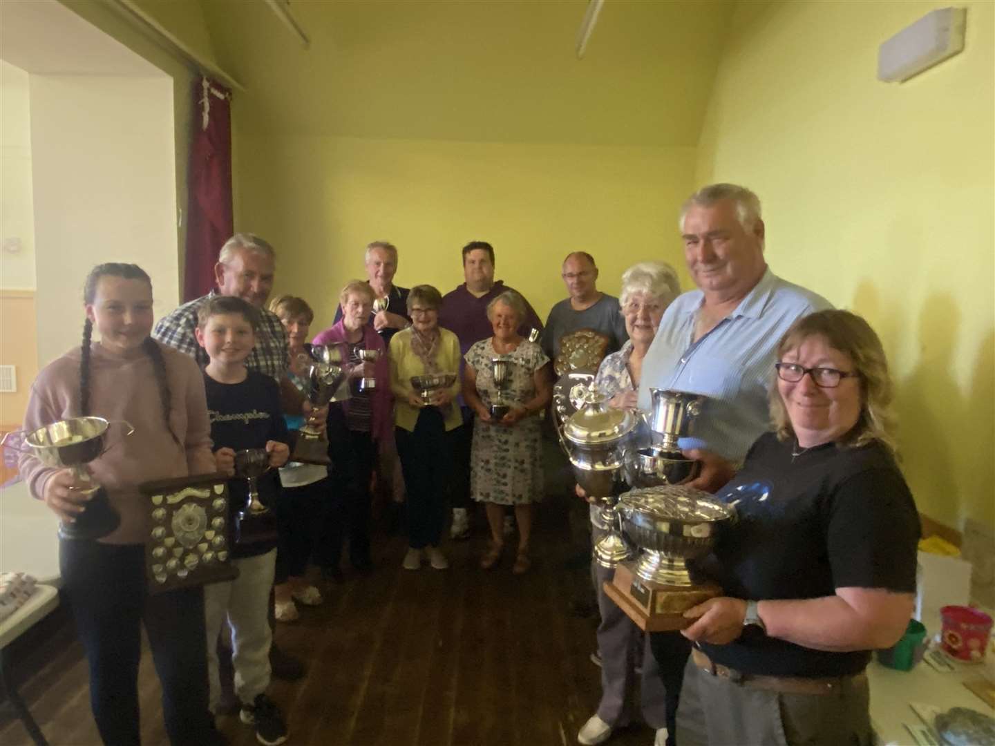 Rhona Lewis (right) and Alan Morrison (second right) show off their Rose Bowl and Baldwin Cup trophies respectively, after being presented with them by Mary Jesson (third right). They are joined by other prizewinners. Picture: HNM