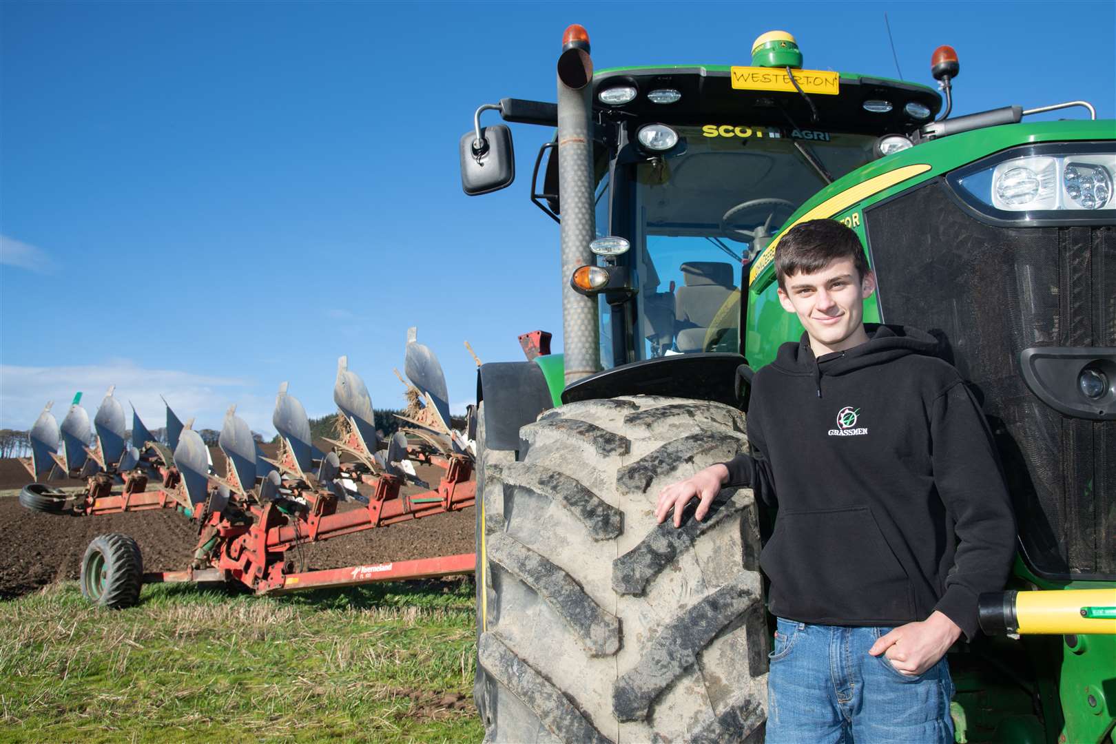 15-year-old Mark Paterson alongside the John Deere tractor he uses to plough at the family's Westerton farm. ..Picture: Daniel Forsyth..