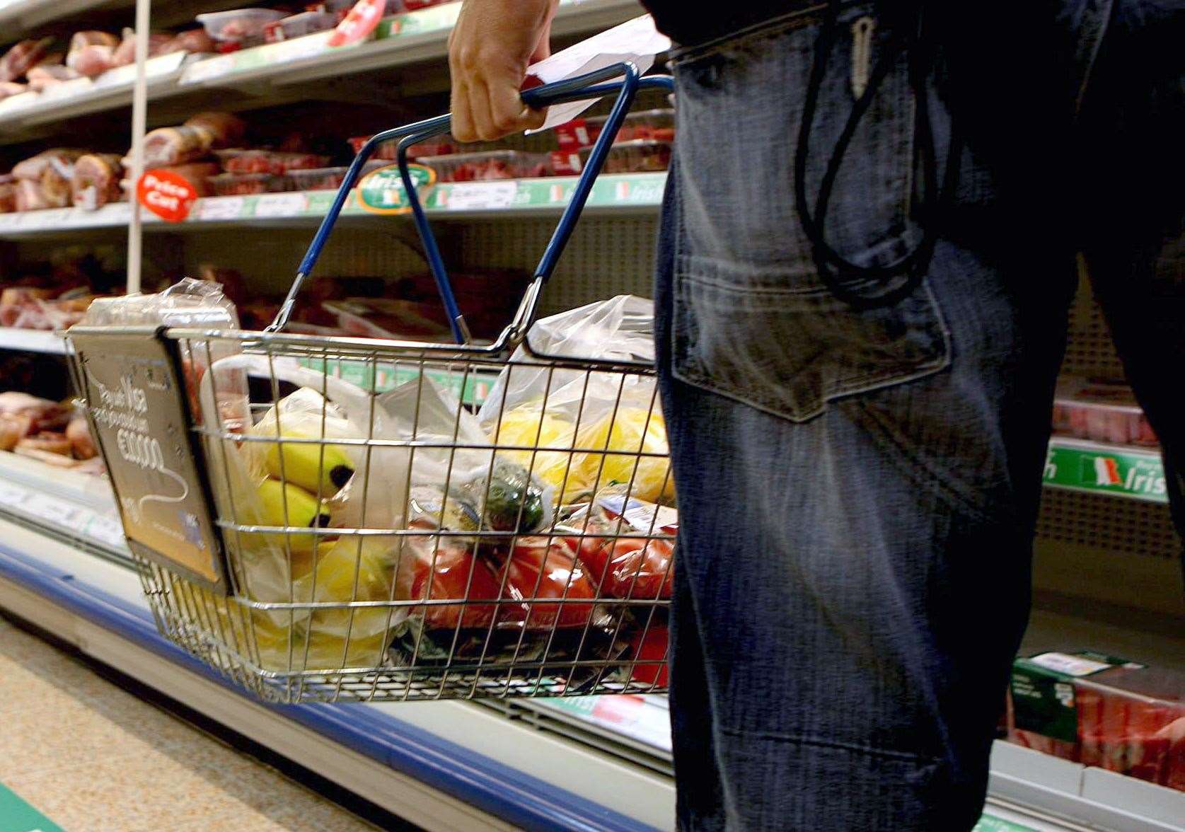 A person holding a shopping basket in a supermarket (Julien Behal/PA)