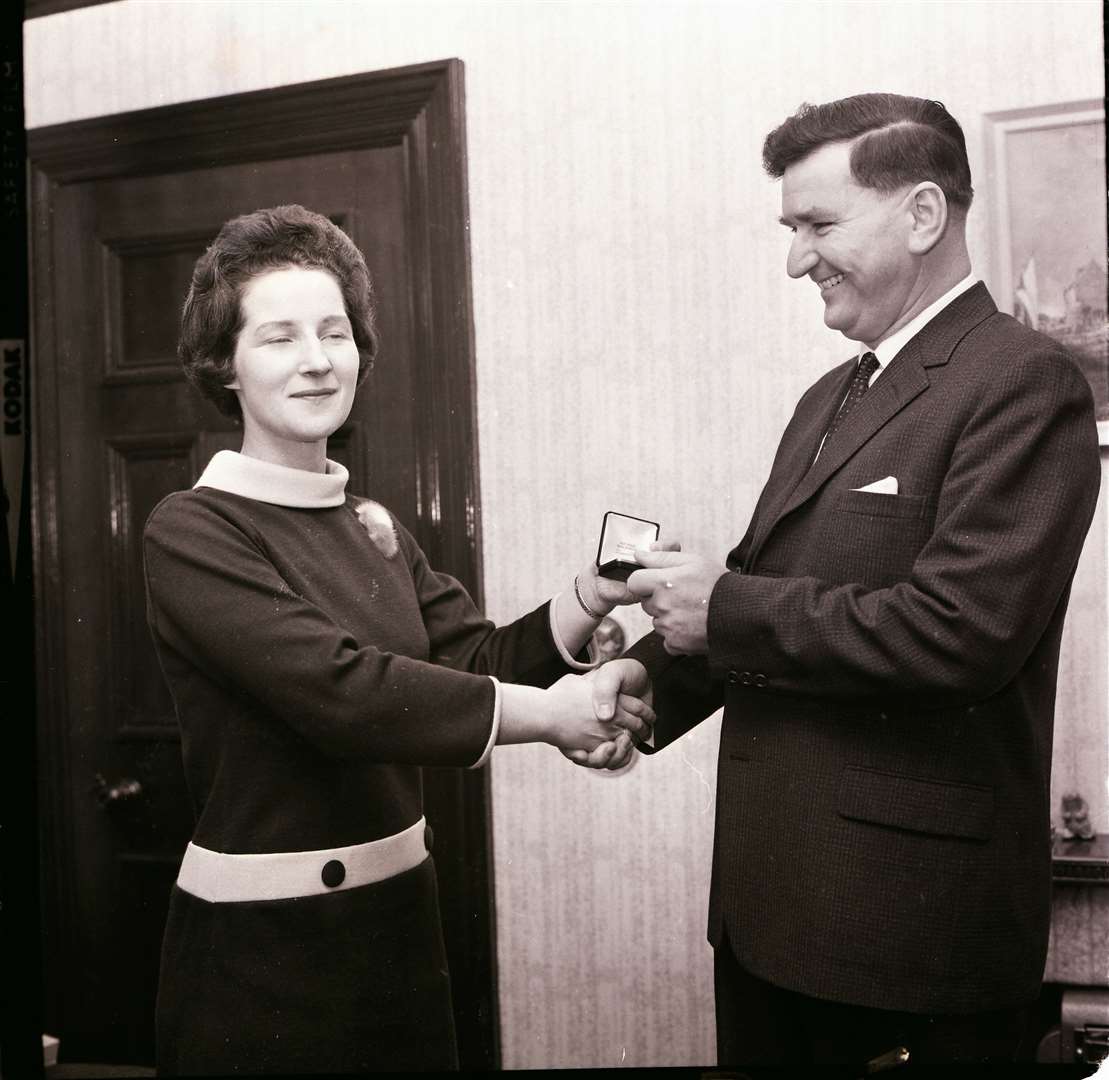 Tom Morrow receives a leaving gift presented by Margaret Reid.