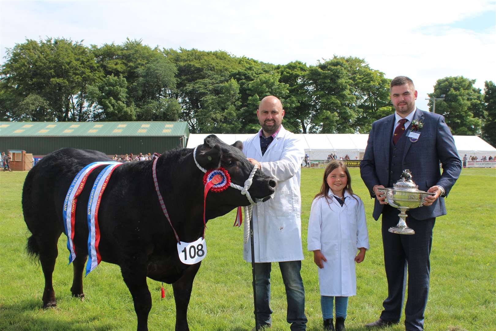 The Champion of Champions at New Deer Show a Limousin cross heifer handled by Steven and Lily Smith, with judge Gavin Ingram. Picture: Kyle Ritchie