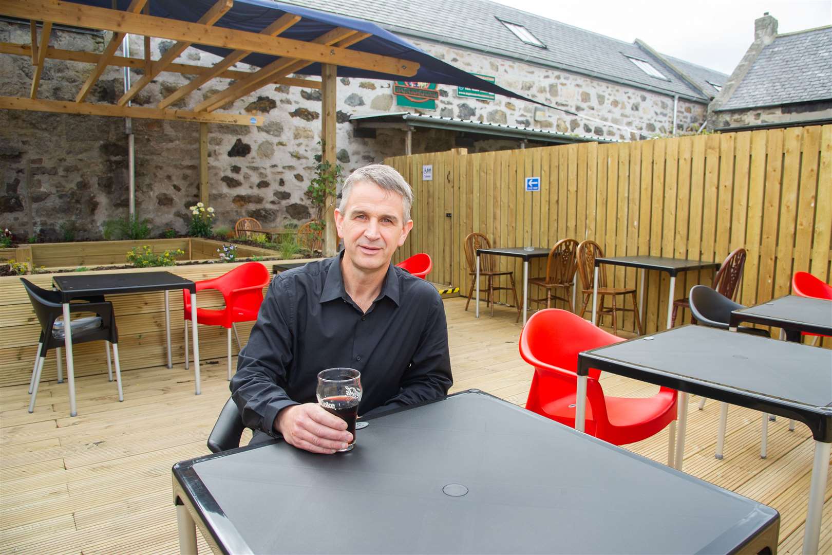 Cheers café/bar owner Paul Slater in the new garden dining area. Picture: Daniel Forsyth.