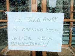 Sign in the window says the takeaway was opening soon under new management.