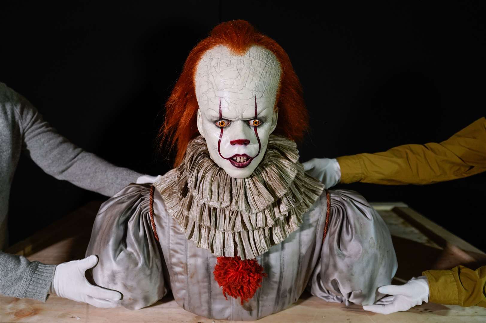 Propstore employees move a Pennywise (Bill Skarsgard) make up display from the 2019 film IT: Chapter Two (Andrew Matthews/PA)
