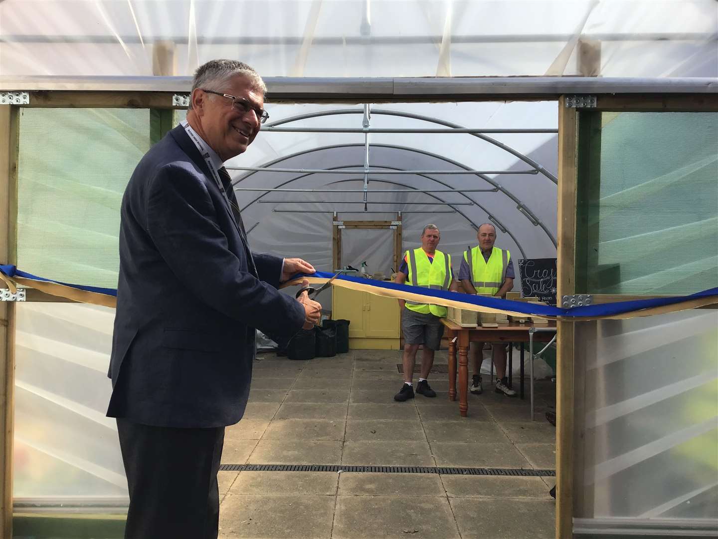 The Lord Lieutenant of Banffshire Andrew Simpson cuts the ribbon to officially open the polytunnel. Picture: BCHS