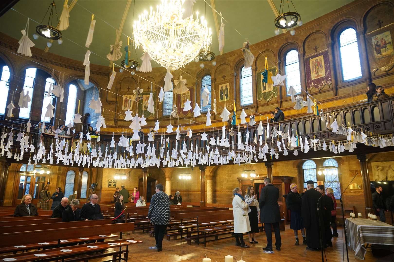 Some 461 paper angels, one for each child that has died in the past year according to the official statistics, hang from the roof ahead of an ecumenical prayer service at the Ukrainian Catholic Cathedral in London to mark the one year anniversary of the Russian invasion of Ukraine (Yui Mok/PA)