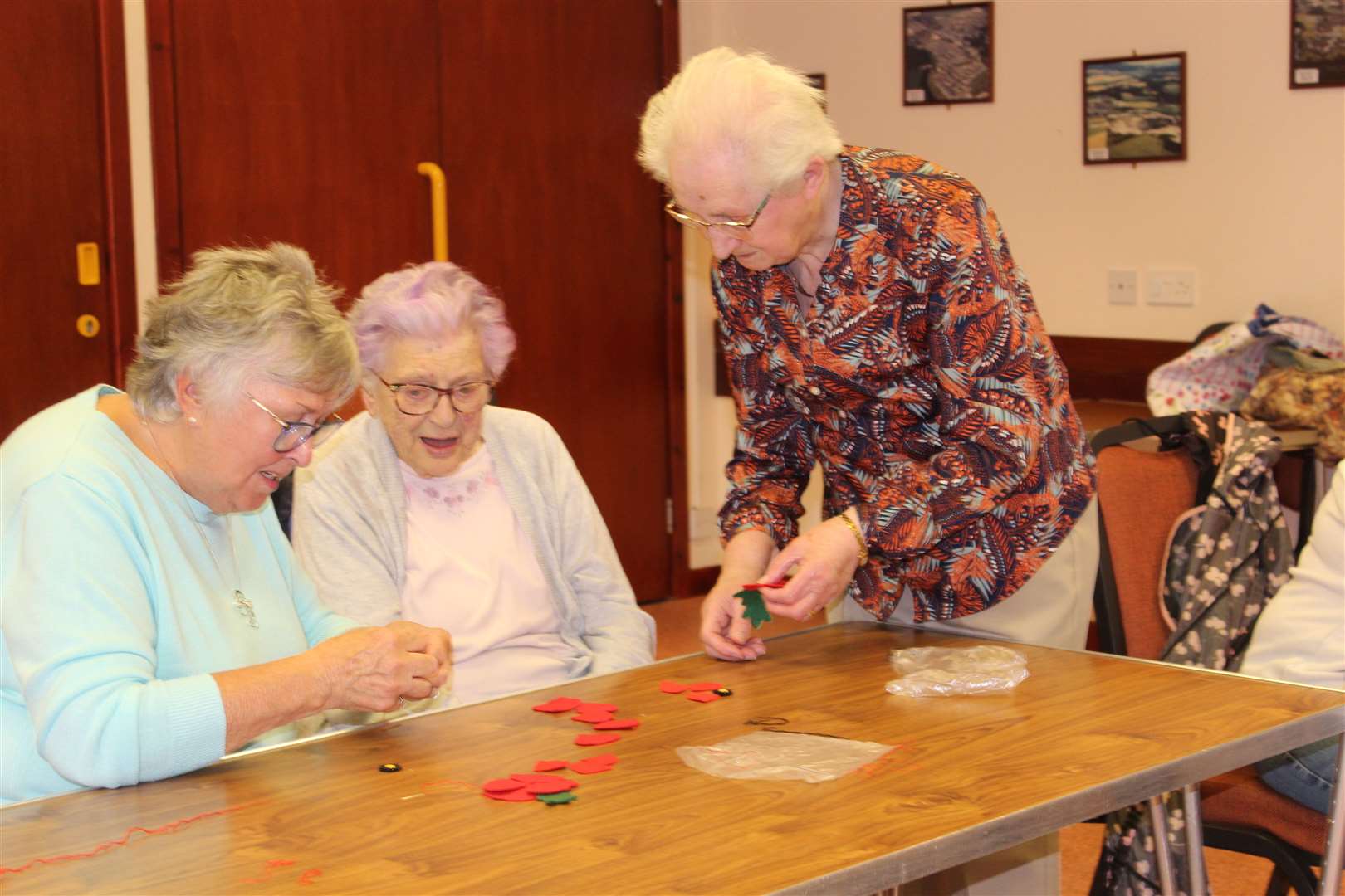 Convenor Mary Michie advises two poppy-makers Anne Middleton and Betty Ewan at the Tuesday centre meeting in Kemnay village hall. Picture: Griselda McGregor