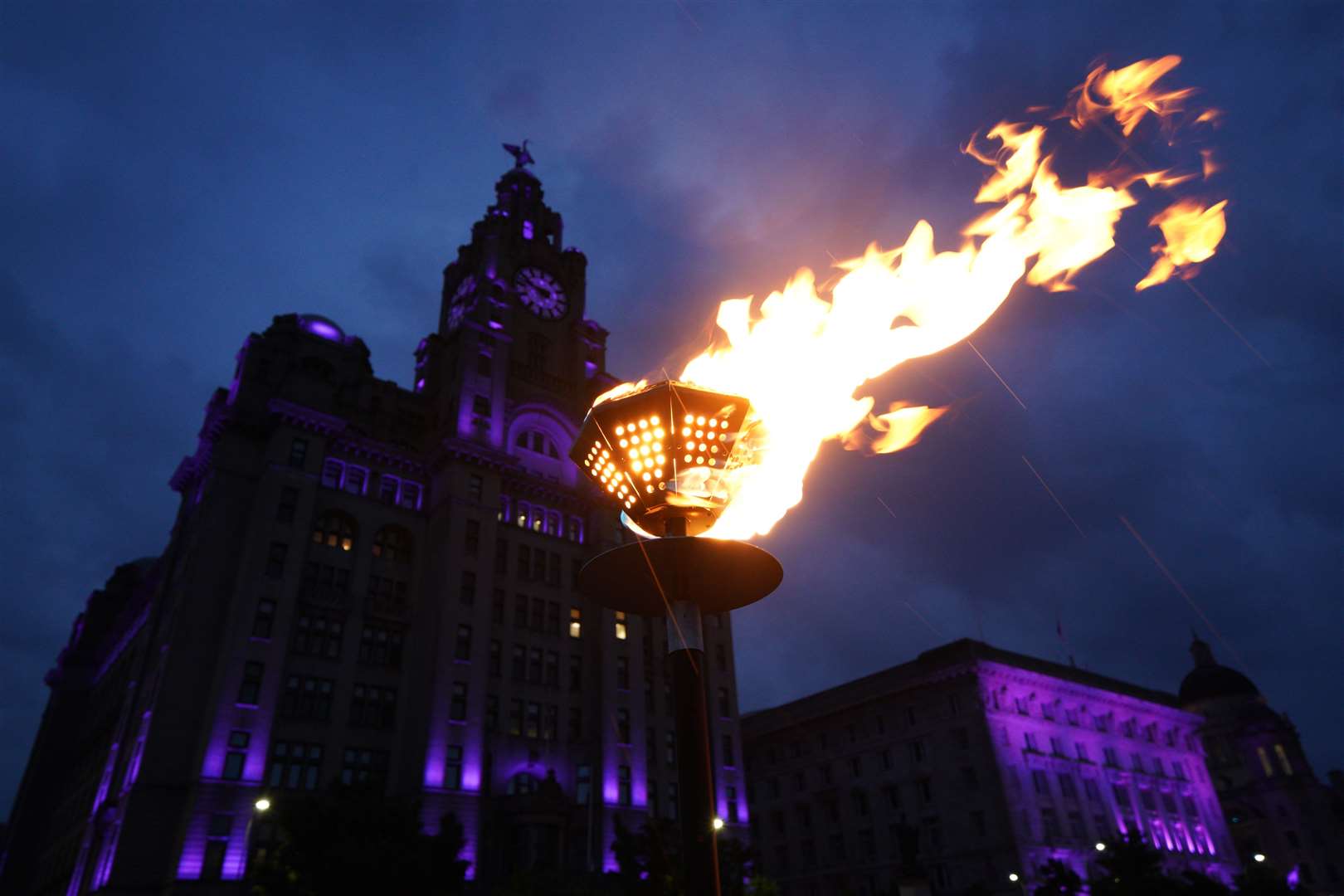 Beacons are lit outside the Royal Liver Building in Liverpool (Peter Byrne/PA)