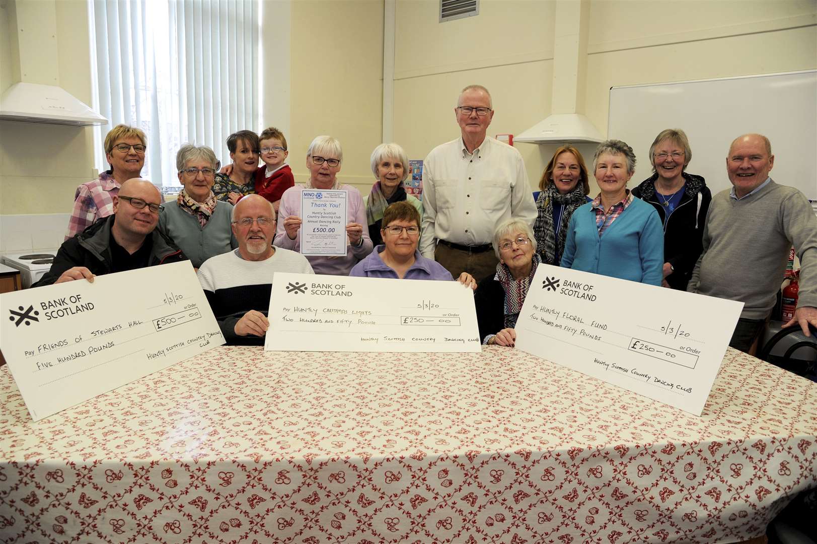 Cheque presentation to Huntly local charities, Stewart's Hall, Christmas Lights and the Floral Fund. Front row l-r: JP Gallagher [Stewarts Hall], Brian Morris [Christmas Lights], Jess McIntosh [Christmas Lights], Jenny Smith [Huntly Floral Club] and Isobell McGregor [centre], MND Scotland.
