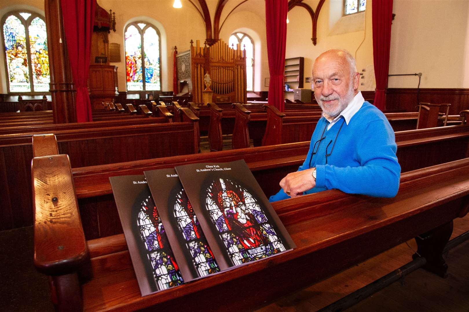 Ted Andrews with copies of a book about the history of Glass Church that are being sold to raise money for the Aberdeenshire kirk. ..Picture: Daniel Forsyth..