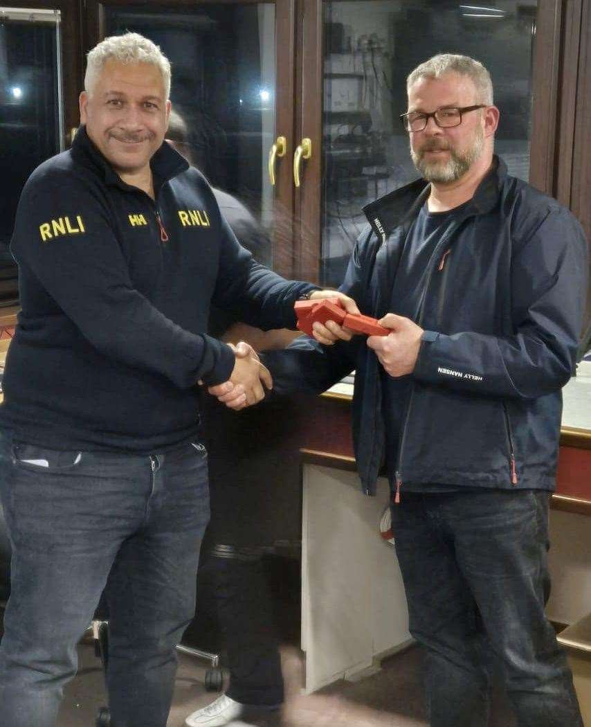 Mike Rennie receives his long service medal. Picture: Buckie RNLI