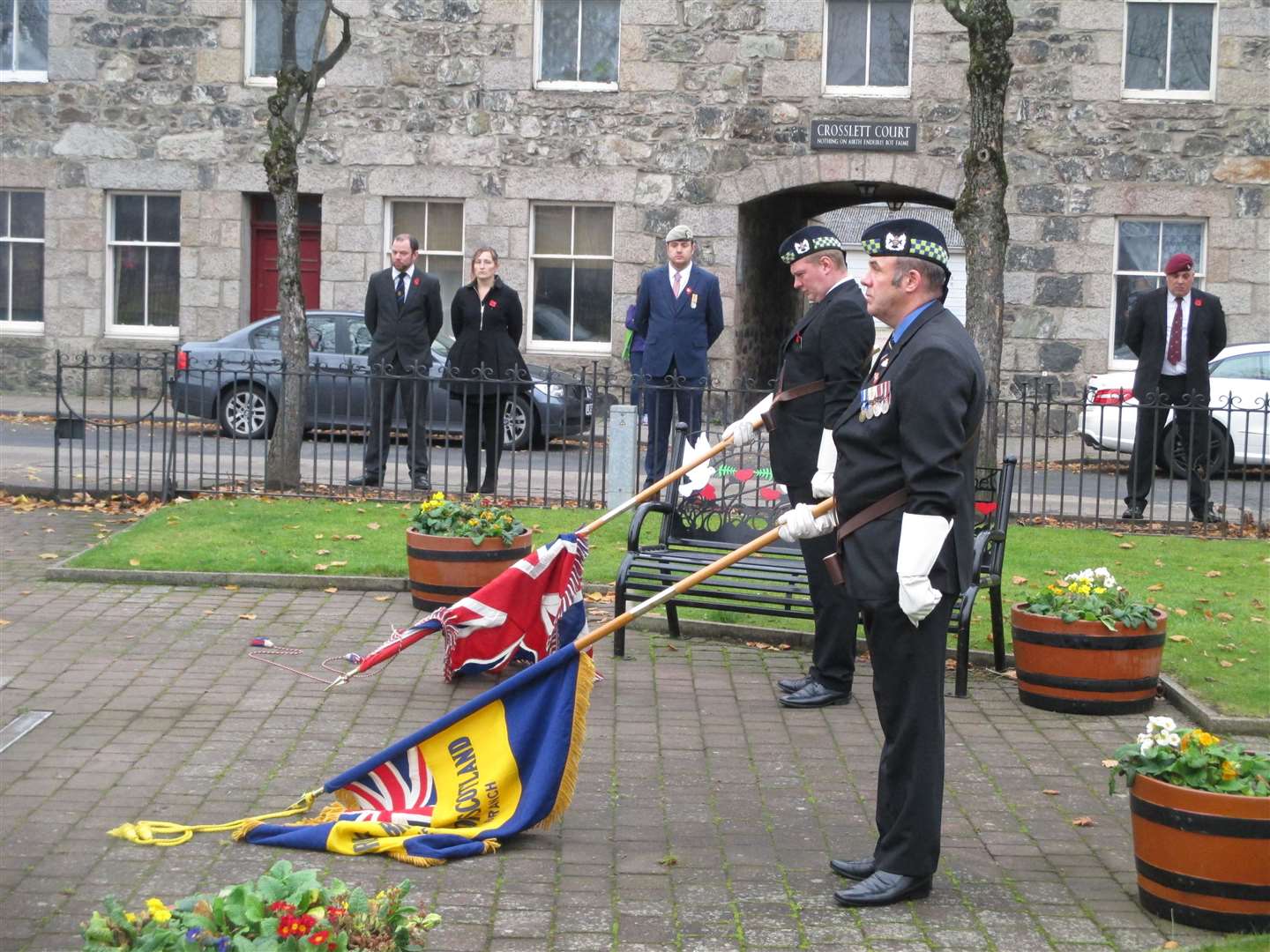 Members of the Inverurie branch of the Royal British Legion lower their flags during the two-minute silence.