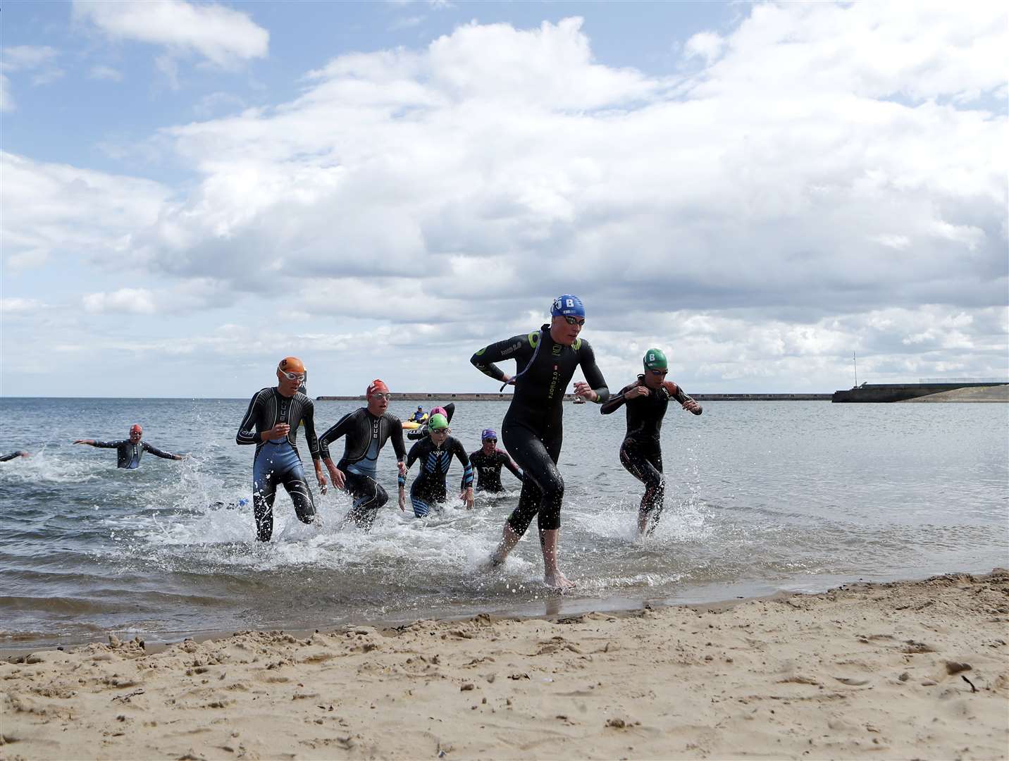 Competitors exit the water during the mixed relay event on day two of the 2023 World Triathlon Series event at Roker Beach, Sunderland on July 30 (Will Matthews/PA)