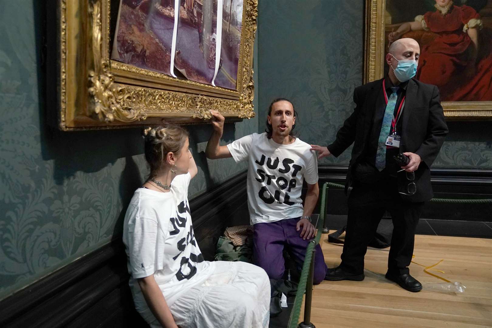 Protesters from Just Stop Oil climate protest group covered John Constable’s The Hay Wain with their own picture inside the National Gallery, London (Kirsty O’Connor/PA)