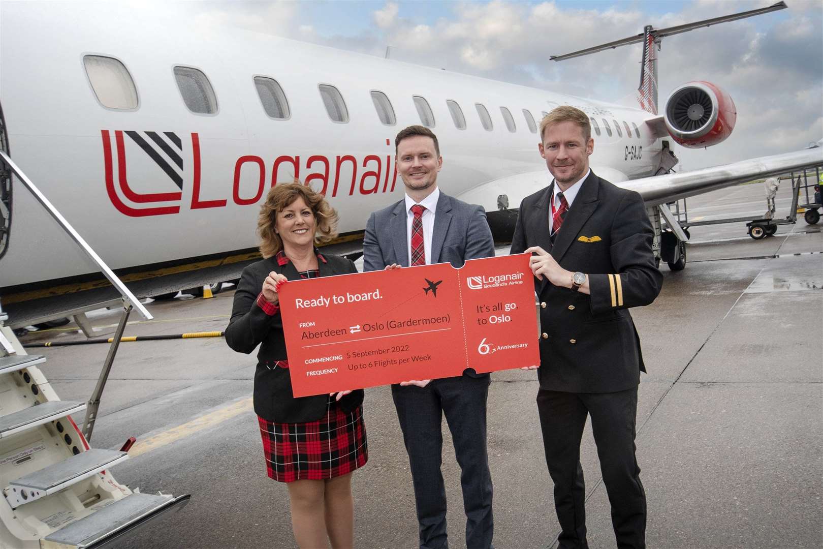 Crew member Beverly LAw (left) with CCO Loganair Luke Lovegrove and First Officer Jordan Cameron at Aberdeen Airport.