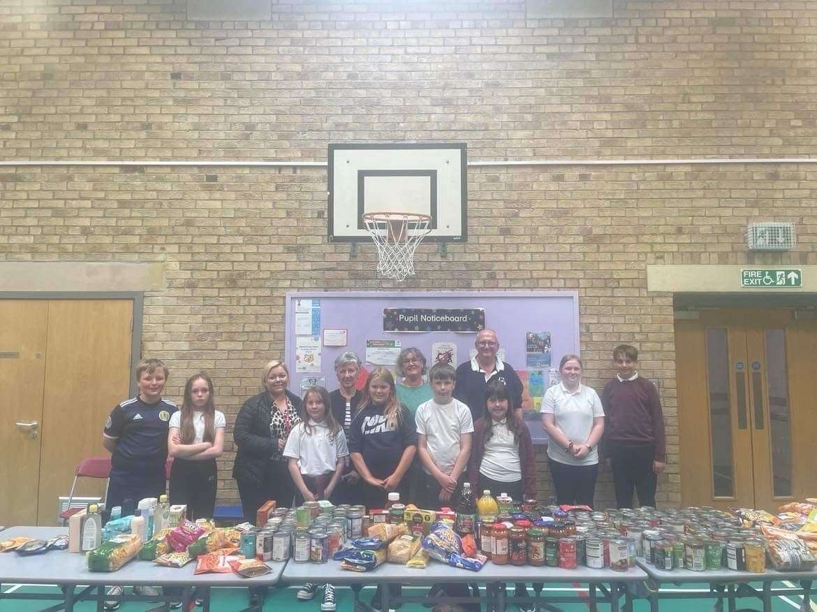 Millbank pupils hand over the school's donation to the food larder to the Buckie Salvation Army Corps visitors. Picture: Buckie Salvation Army Corps