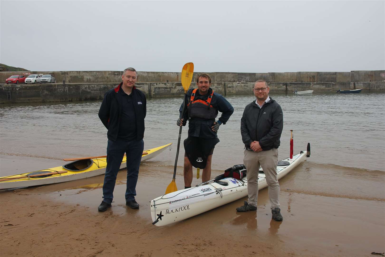 Meeting Jack Gatacre as he comes ashore at Collieston were The Fisherman's Mission's Sandy Garvock and MP Richard Thomson. Picture: Kirsty Brown