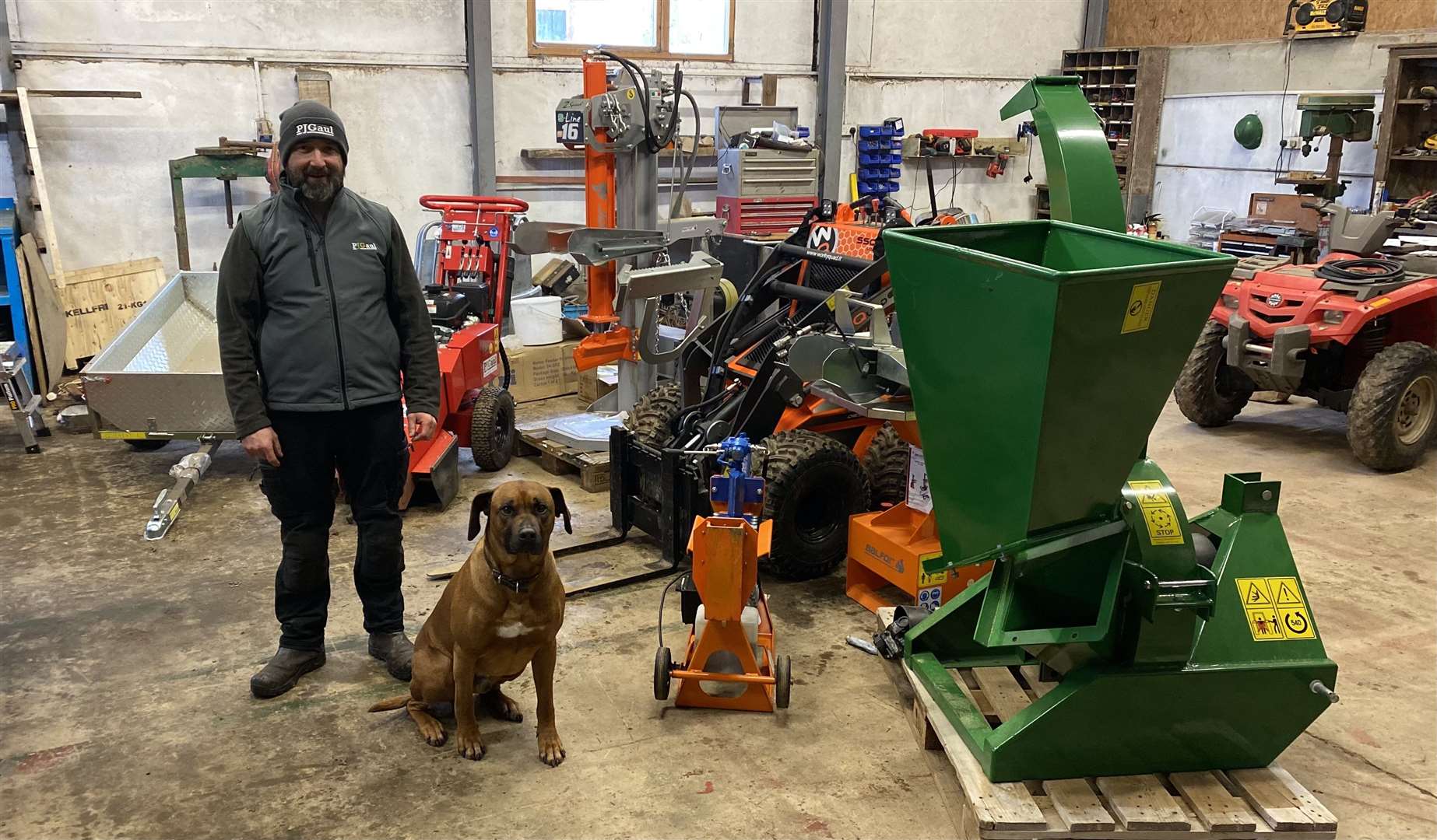 Alan Gaul and his dog Tau in the workshop of the family business.