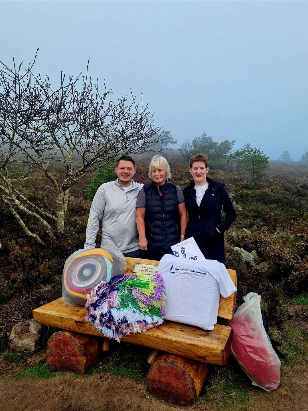 Matthew Sunter, Lorraine Grant and Jenny Rae take a break at the bench which they themselves carried up the hillside last year.