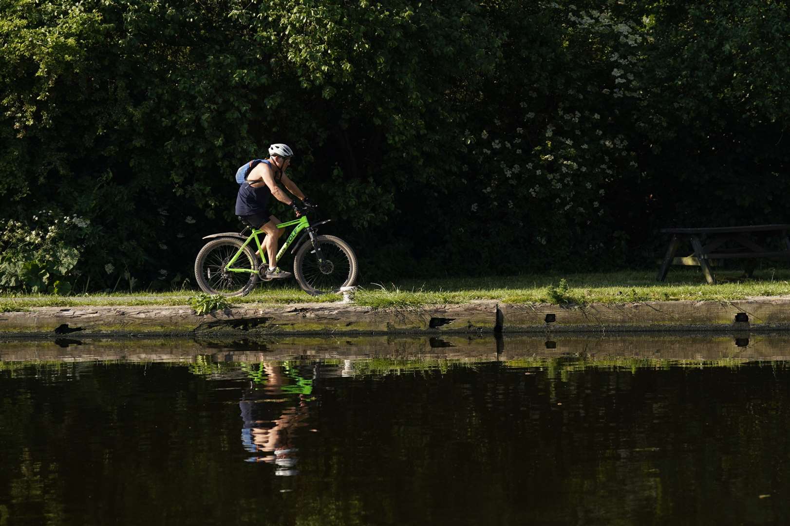 A man cycles along the Aire and Calder navigation, in Woodlesford in Leeds (Danny Lawson/PA)