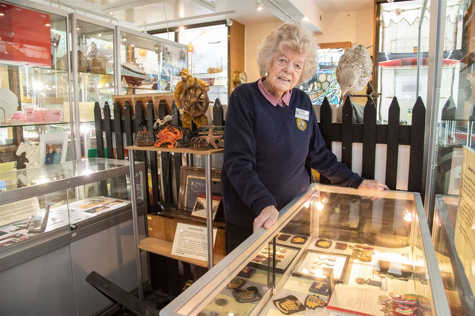 Kath Macleod examines some of the military medals and insignia on show. Picture: Daniel Forsyth