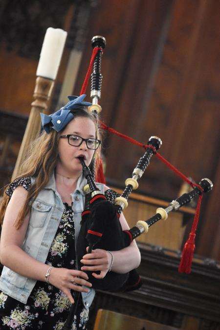 Cassie Findlay plays the bagpipes in St Rufus Church