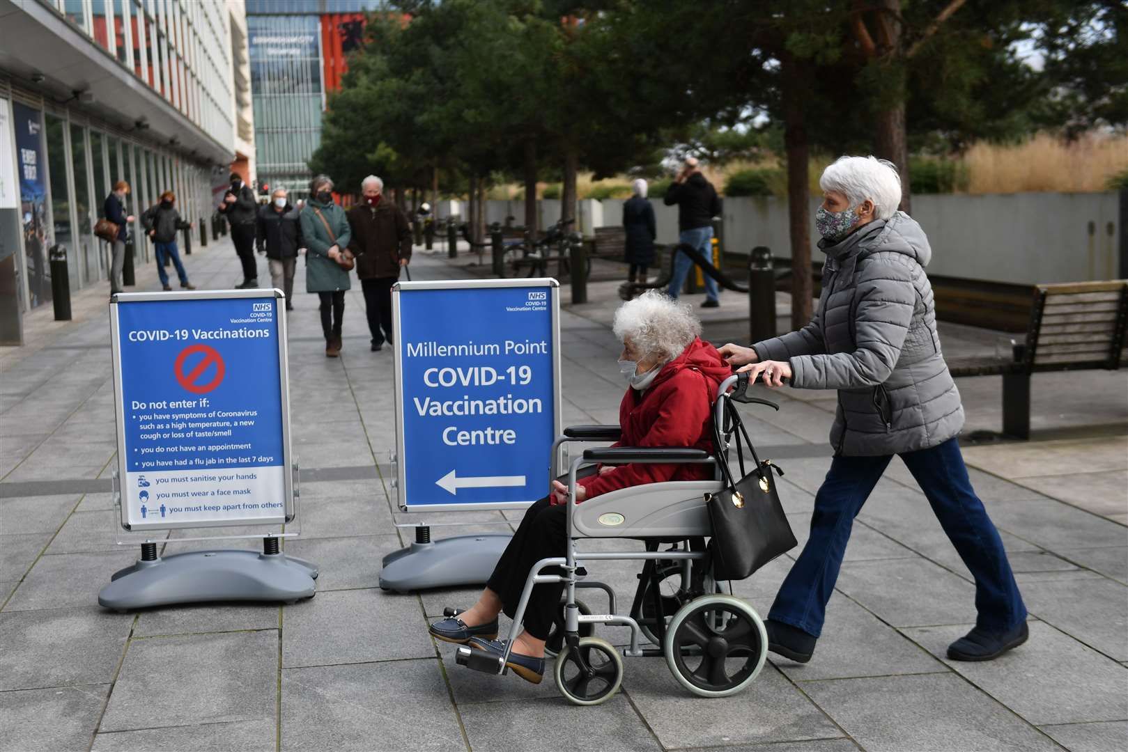 Members of the public arrive to receive their Covid-19 jab at the NHS vaccine centre at Millennium Point centre in Birmingham (Jacob King/PA)