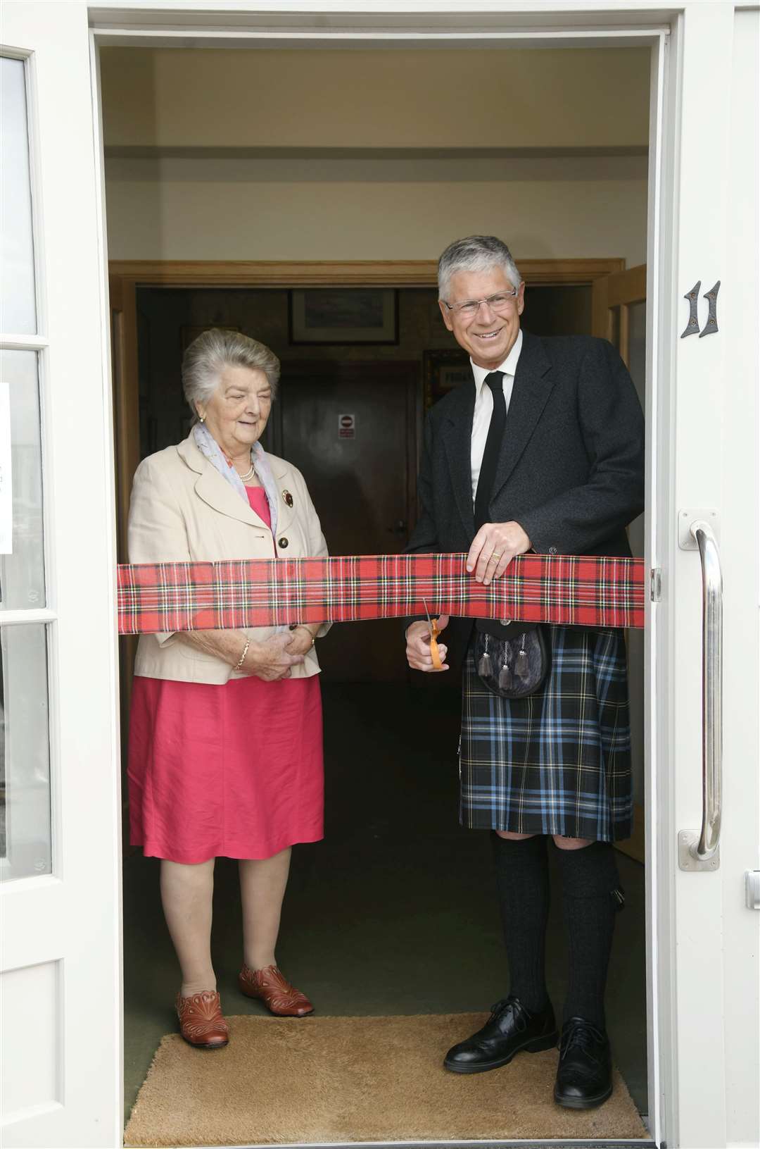Lord Lieutenant Andrew Simpson cuts the ribbon to officially declare Cullen Heritage Centre open, watched by CDPHG President Brenda Wood. Picture: Beth Taylor