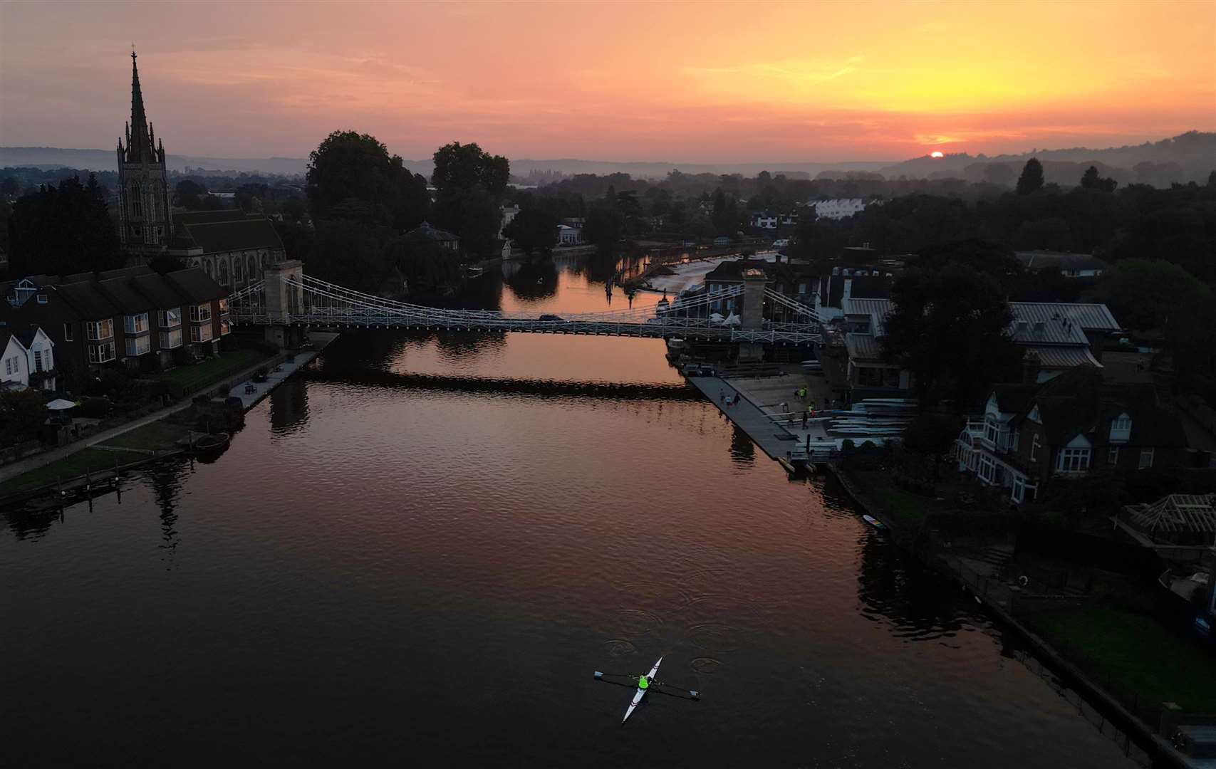 The sun rises over Marlow in Buckinghamshire and its Grade 1 listed bridge which spans the River Thames (Jonathan Brady/PA)