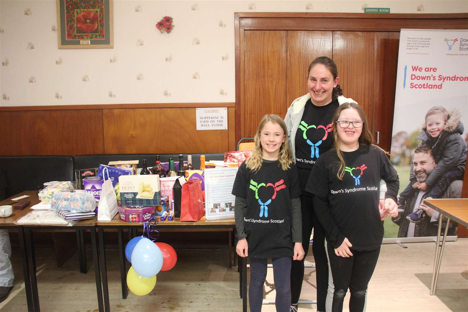 A coffee morning which raised ____ for Down Syndrome Scotland was organised by Veronica Francis, pictured with daughters Caitlin and Joanna. Picture: Kirsty Brown