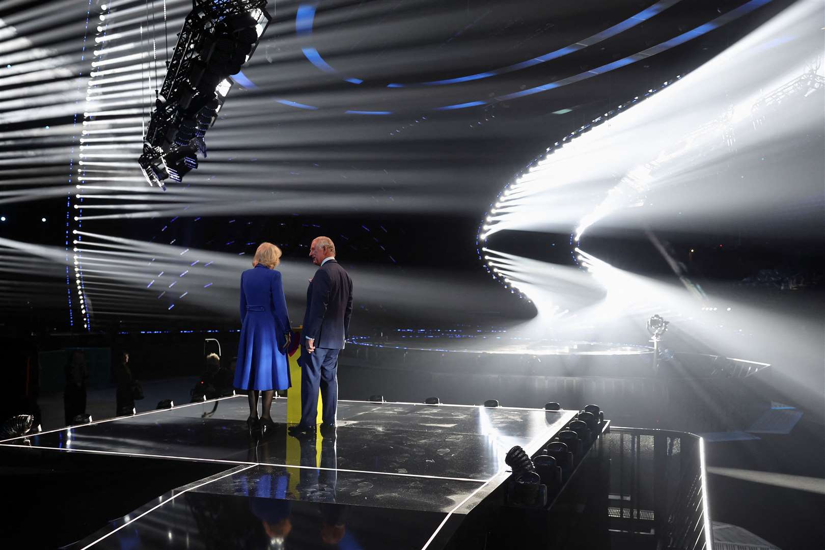The King and the Queen Consort stand on the stage after switching on the stage lighting, during a visit to the M and S Bank Arena, the host venue of this year’s Eurovision Song Contest (Phil Noble/PA)