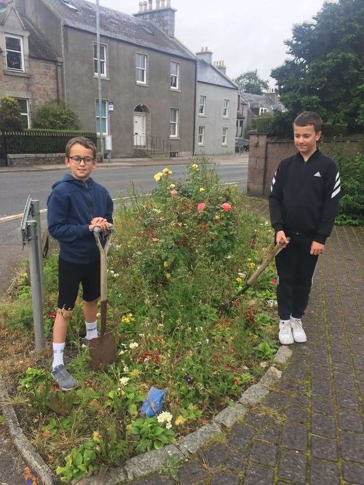 Brothers Max and Ben who are helping to tidy up the council garden in the next two weeks