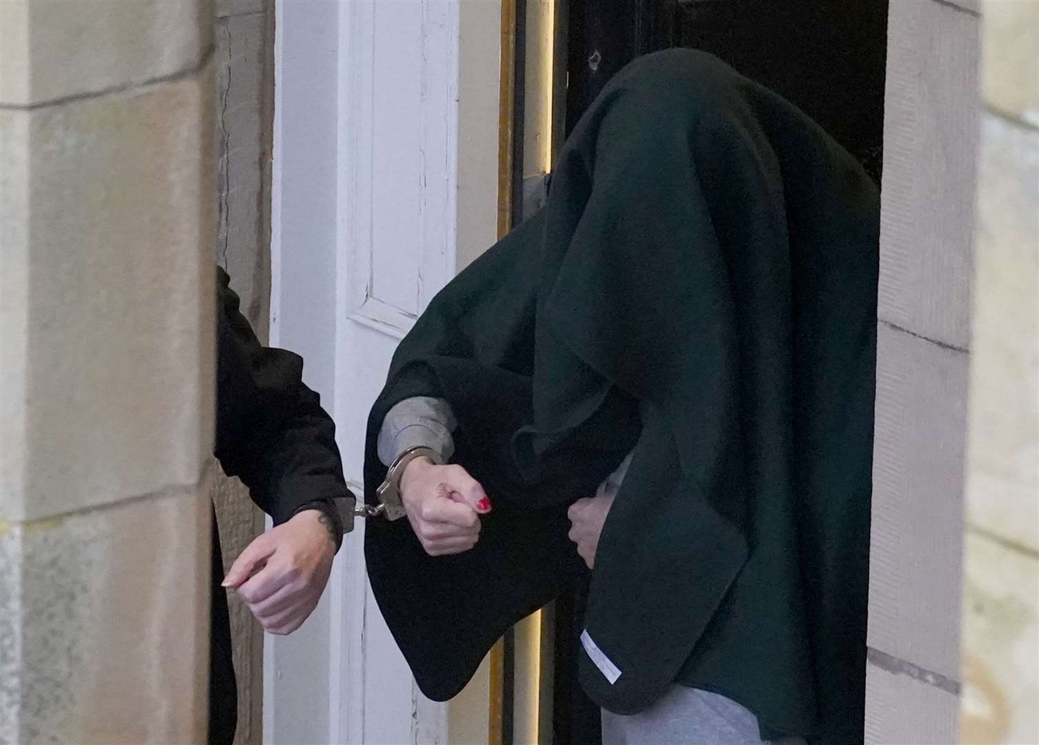 Andrew Miller, with his head covered, is appealing against his sentence (PA)
